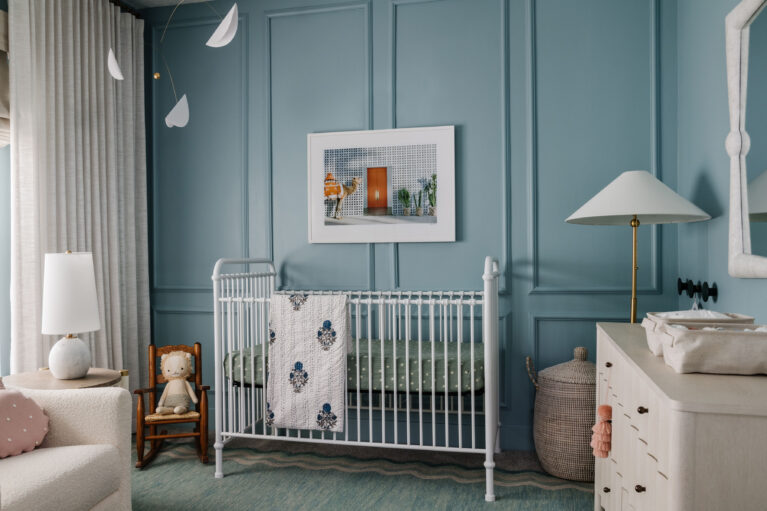 Blue gender neutral nursery by Jenilee Greene Design with crib, drapery and mobile