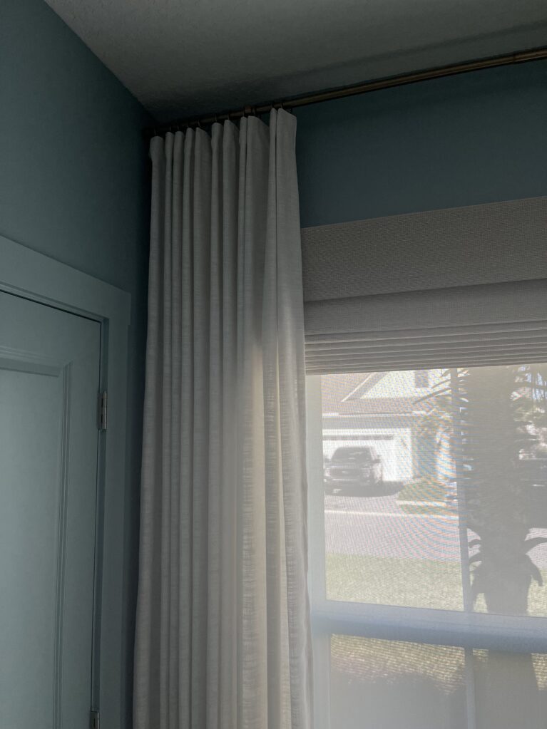 layered window treatments withs solar shade, woven wood roman shade and floor to ceiling drapery by TWOPAGES